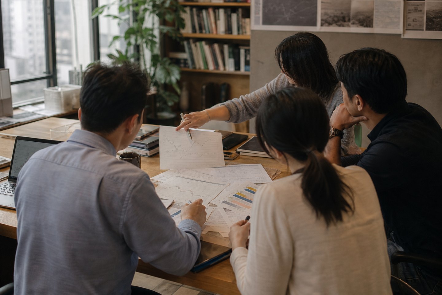 Editorial team comparing evidence around a table